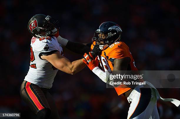 Von Miller of the Denver Broncos blocks Nate Byham of the Tampa Bay Buccaneers during the game at Sports Authority Stadium on December 2, 2012 in...