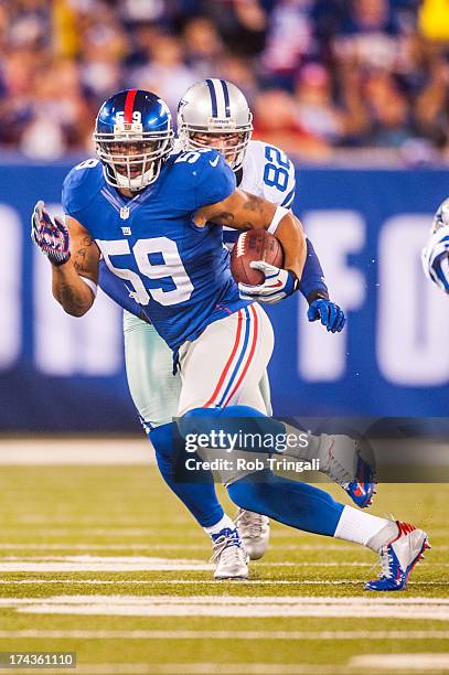 Linebacker Michael Boley of the New York Giants runs the ball after an interception during the game against the Dallas Cowboys at MetLife Stadium on...