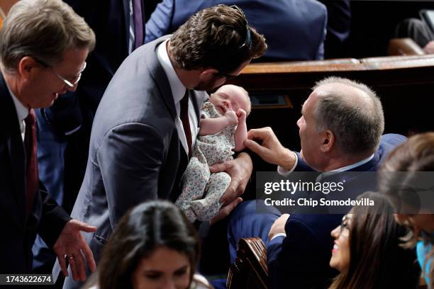 Rep. Dan Crenshaw holds Florida Republican Rep. Anna Paulina Luna's baby alongside Rep. Tim Burchett and Rep. Trent Kelly as the House of...