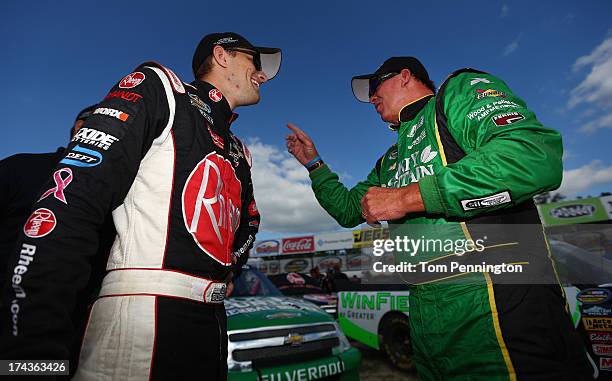 James Buescher, driver of the Rheem Chevrolet, and Ron Hornaday Jr., driver of the Smokey Mountain Herbal Snuff Chevrolet, talk after qualifying for...