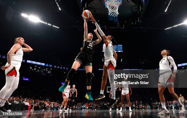 Sabrina Ionescu of the New York Liberty drives to the basket and is blocked by A'ja Wilson of the Las Vegas Aces in the first half during Game Four...