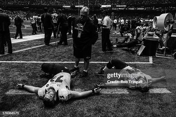 Marshal Yanda and Matt Birk of the Baltimore Ravens stretch during the power outage in the third quarter, suspending play during Super Bowl XLVII on...