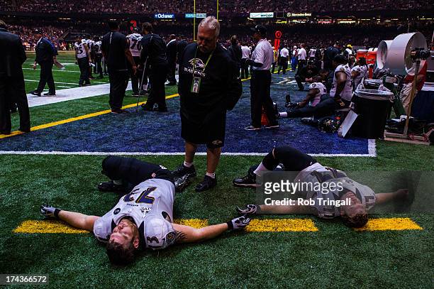 Marshal Yanda and Matt Birk of the Baltimore Ravens stretch during the power outage in the third quarter, suspending play during Super Bowl XLVII on...