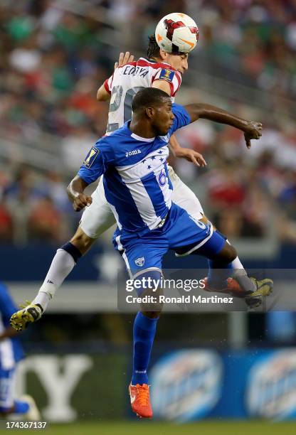 Alejandro Bedoya of the United States jumps for a header with Juan Carlos Garcia of Honduras during the CONCACAF Gold Cup semifinal match at Cowboys...
