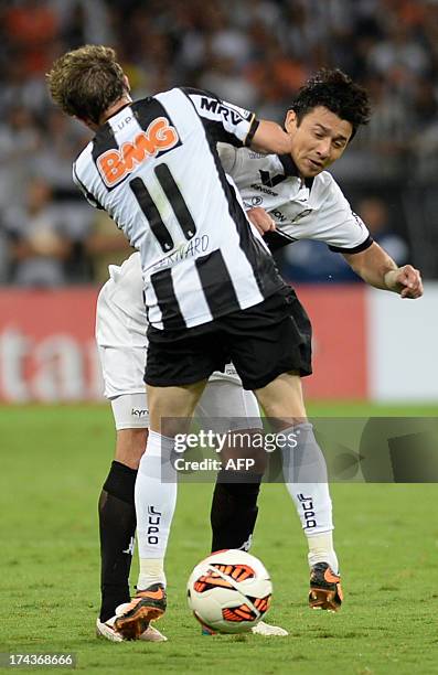 Bernard of Brazil's Atletico Mineiro, fouls Eduardo Aranda, of Paraguay's Olimpia, during their Libertadores Cup second leg football final at the...