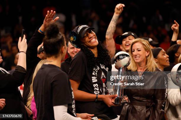 Ja Wilson of the Las Vegas Aces celebrates with the MVP trophy after defeating the New York Liberty during Game Four of the 2023 WNBA Finals at...