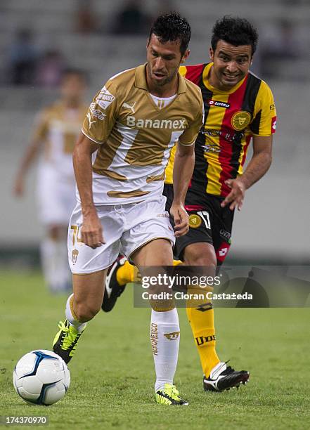 Luis Garcia of Pumas competes for the ball with Angel Diaz of Leones Negros during a match between Leones Negros and Pumas, as part of the Cup MX at...