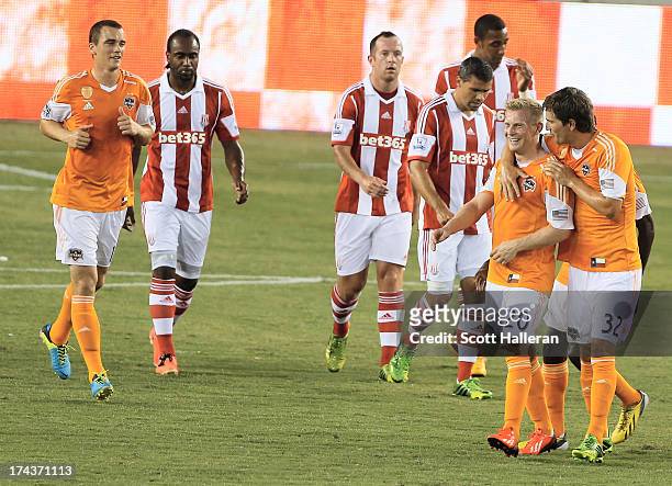 Andrew Driver and Bobby Boswell of the Houston Dynamo celebrate after Driver scored a first half goal against Stoke City during the Dynamo Charities...