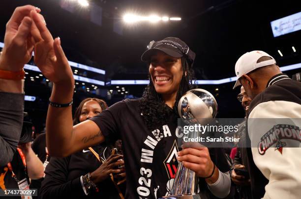 Ja Wilson of the Las Vegas Aces celebrates with the MVP trophy after defeating the New York Liberty during Game Four of the 2023 WNBA Finals at...