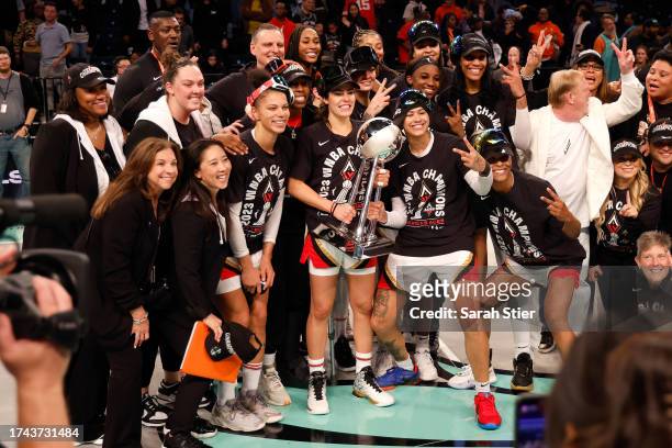 Kelsey Plum of the Las Vegas Aces holds the trophy while celebrating with her team after defeating the New York Liberty during Game Four of the 2023...