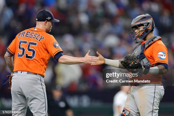 Ryan Pressly and Martin Maldonado of the Houston Astros celebrate after defeating the Texas Rangers in Game Three of the American League Championship...