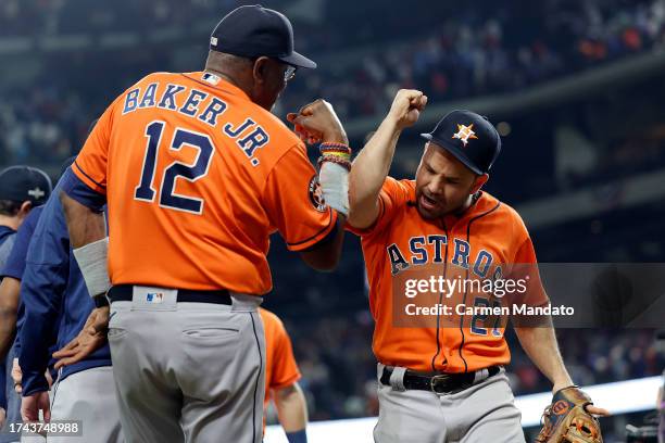 Jose Altuve of the Houston Astros celebrates with manager Dusty Baker after defeating the Texas Rangers in Game Three of the American League...