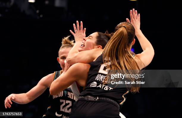 Kelsey Plum of the Las Vegas Aces drives to the basket against Sabrina Ionescu of the New York Liberty in the fourth quarter during Game Four of the...