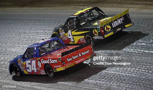 Darrell Wallace Jr., driver of the Camping World/Good Sam Toyota, races Jeb Burton, driver of the Arrowhead Chevrolet, for position during the NASCAR...