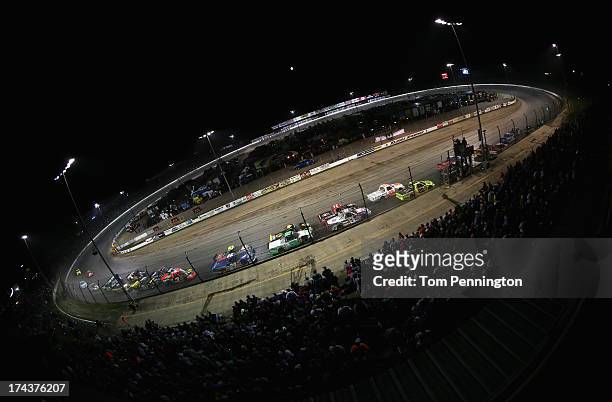 Drivers race to the start finish line on a double file restart during the NASCAR Camping World Truck Series inaugural Mudsummer Classic at Eldora...