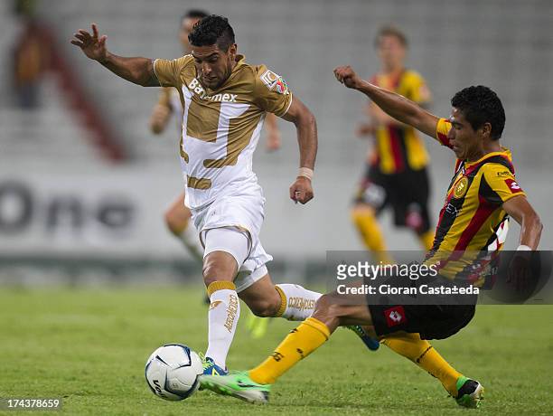 Martin Bravo of Pumas competes for the ball with Jose Diaz of Leones Negros during a match between Leones Negros and Pumas, as part of the Cup MX at...