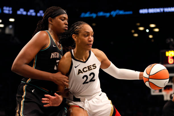 Ja Wilson of the Las Vegas Aces dribbles against Jonquel Jones of the New York Liberty in the fourth quarter during Game Four of the 2023 WNBA Finals...