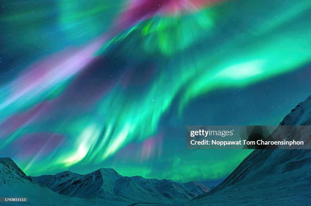 Strong Kp index Aurora Borealis (Northern Lights) exploding over the Alaskan peaks near Atigun Pass along the Dalton Highway, located to the north of Fairbanks, Alaska, USA.