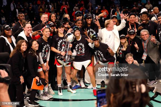 Kelsey Plum of the Las Vegas Aces holds the trophy while celebrating with her team after defeating the New York Liberty during Game Four of the 2023...