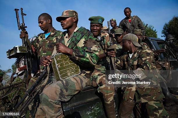 Armed members of the M23 rebel group travel to a frontline position overlooking Goma, in the shadow of the Nyiragongo Volcano, in the eastern...