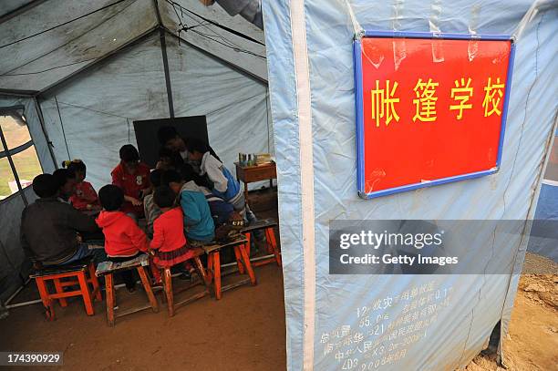 Children attend a class in a shelter at Yongxing village on July 24, 2013 in Minxian, China. At least 95 people were killed and more than 1,000...