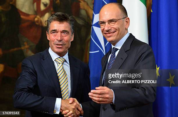 Secretary-General Anders Fogh Rasmussen poses with Italian Prime Minister Enrico Letta during their meeting on July 25, 2013 at Chigi palace in Rome....
