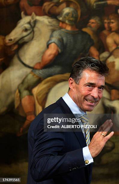 Secretary-General Anders Fogh Rasmussen waves to the press as arrives for the meeting with Italian Prime Minister Enrico Letta on July 25, 2013 at...