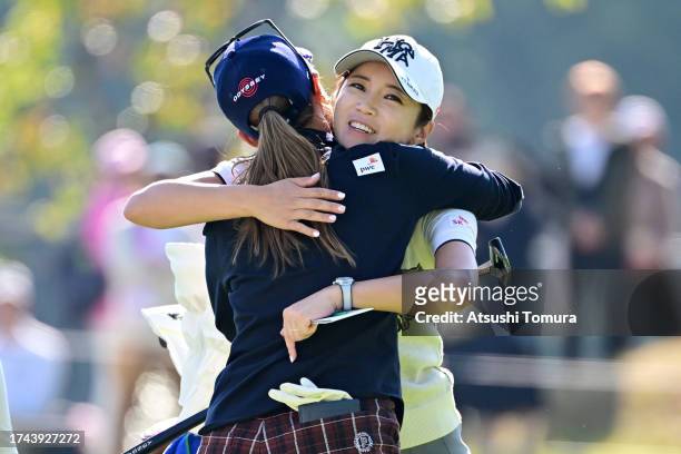 Momoko Ueda of Japan and Bo-mee Lee of South Korea embrace after holing out on the 9th green during the first round of NOBUTA Group Masters GC Ladies...