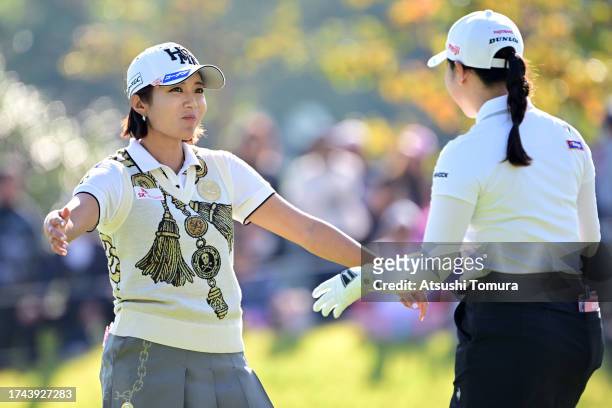 Bo-mee Lee of South Korea and Sakura Koiwai of Japan embrace after holing out on the 9th green during the first round of NOBUTA Group Masters GC...