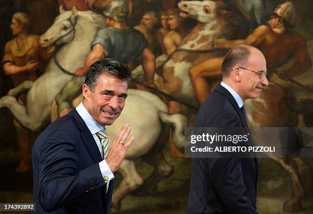 Secretary-General Anders Fogh Rasmussen waves to the press as arrives for the meeting with Italian Prime Minister Enrico Letta on July 25, 2013 at...