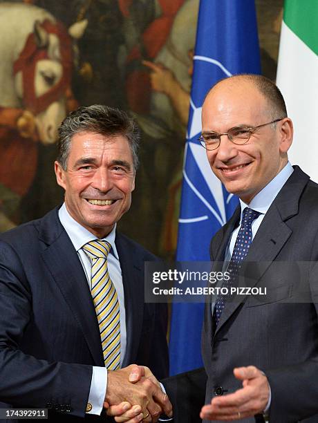 Secretary-General Anders Fogh Rasmussen poses with Italian Prime Minister Enrico Letta during their meeting on July 25, 2013 at Chigi palace in Rome....