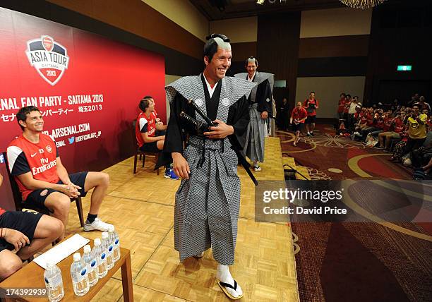 Lukas Podolski of Arsenal FC poses dressed as a Samurai Warrior as he puts on a demostration for the Arsenal Fans Party in the Urawa Royal Pines...