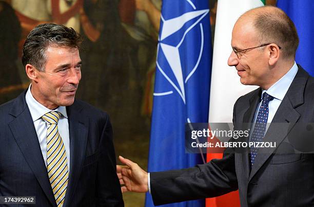 Secretary-General Anders Fogh Rasmussen is greeted by Italian Prime Minister Enrico Letta during their meeting on July 25, 2013 at Chigi palace in...