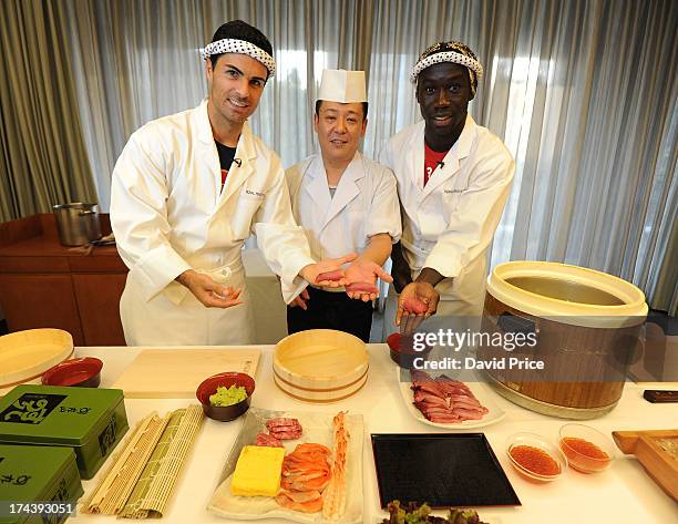 Mikel Arteta and Bacary Sagna of Arsenal FC are given a lesson in making Sushi from a top Sushi Chef in the Urawa Royal Pines Hotel in Japan for the...