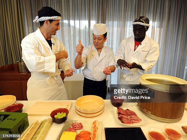 Mikel Arteta and Bacary Sagna of Arsenal FC are given a lesson in making Sushi from a top Sushi Chef in the Urawa Royal Pines Hotel in Japan for the...