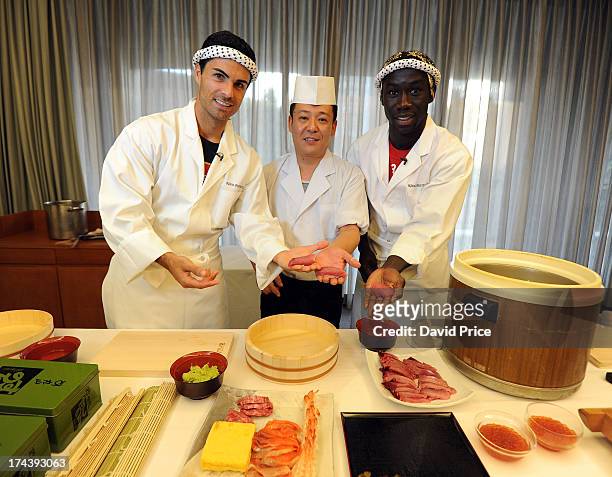 Mikel Arteta and Bacary Sagna of Arsenal FC are given a lesson in making Sushi from a top Sushi Chef in the Urawa Royal Pines Hotel in Japan for the...
