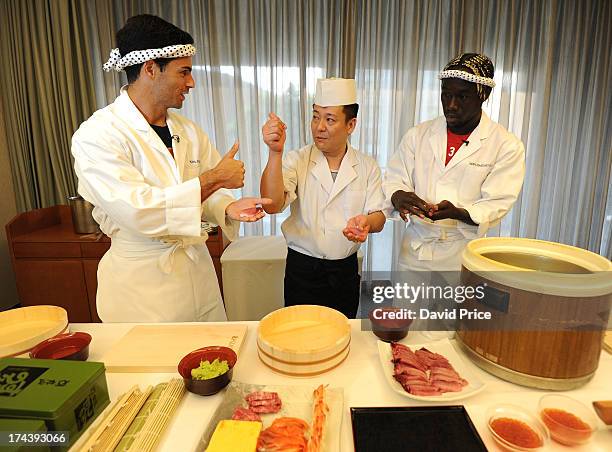 Mikel Arteta and Bacary Sagna of Arsenal FC are given a lesson in making Sushi from a top Sushi Chef in the Urawa Royal Pines Hotel in Japan for the...