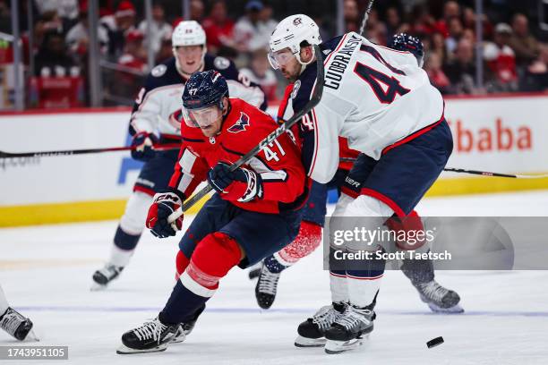 Beck Malenstyn of the Washington Capitals and Erik Gudbranson of the Columbus Blue Jackets battle for the puck during the second period of the NHL...
