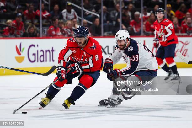 Alex Ovechkin of the Washington Capitals skates with the puck against Boone Jenner of the Columbus Blue Jackets during the first period of the NHL...