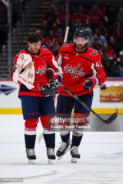 Oshie of the Washington Capitals skates with Tom Wilson while holding a BioSteel Sports Hydration towel after a play against the Columbus Blue...