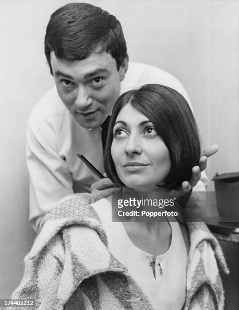 British hairdresser Vidal Sassoon styles the hair of French fashion designer Emmanuelle Khanh at his salon in Old Bond Street, London, 12th September...