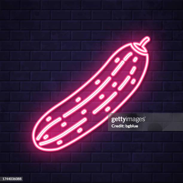 cucumber. glowing neon icon on brick wall background - squash vegetable stock illustrations