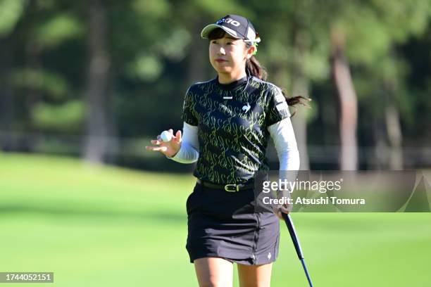 Nana Suganuma of Japan acknowledges the gallery after the birdie on the 15th green during the first round of NOBUTA Group Masters GC Ladies at...