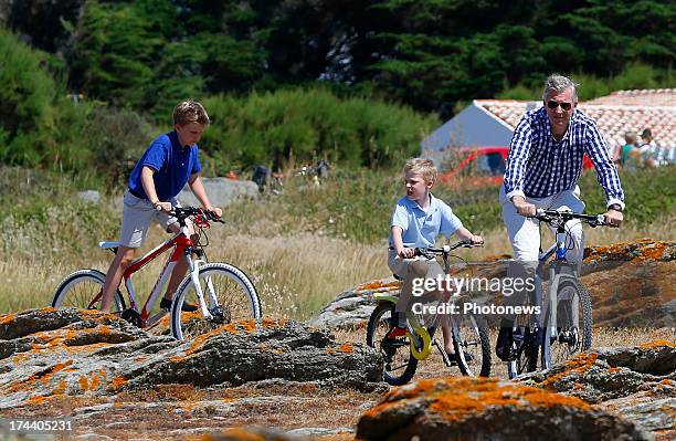 King Philippe, Prince Emmanuel and Prince Gabriel of Belgium riding their bikes during their holiday on l'Ile d'Yeu on July 24, 2013 in Yeu, France.