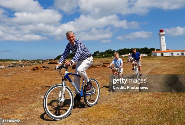 King Philippe, Prince Emmanuel and Prince Gabriel of Belgium riding their bikes during their holiday on l'Ile d'Yeu on July 24, 2013 in Yeu, France.