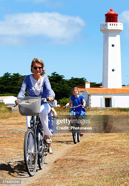 Queen Mathilde of Belgium on her bike and Princess Elizabeth of Belgium at the back during their holiday on l'Ile d'Yeu on July 24, 2013 in Yeu,...