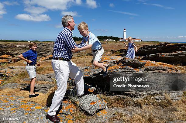 Prince Emmanuel of Belgium jumps into King Philippe's arms during their holiday on l'Ile d'Yeu on July 24, 2013 in Yeu, France.