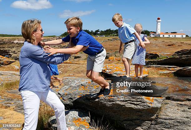 Prince Gabriel of Belgium jumps into King Philippe's arms during their holiday on l'Ile d'Yeu on July 24, 2013 in Yeu, France.