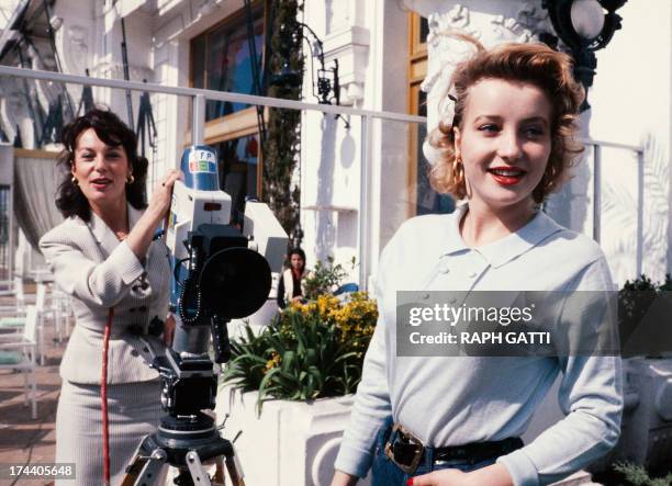 Picture taken on March 14, 1980 shows French actress Bernadette Lafont shooting with a camera her daughter French actress Pauline Lafont during the...