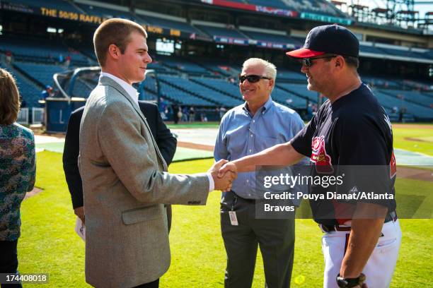 Atlanta Braves first round draft pick Jason Hursh, Atlanta Braves general manager Frank Wren and Roger McDowell of the Atlanta Braves before the game...